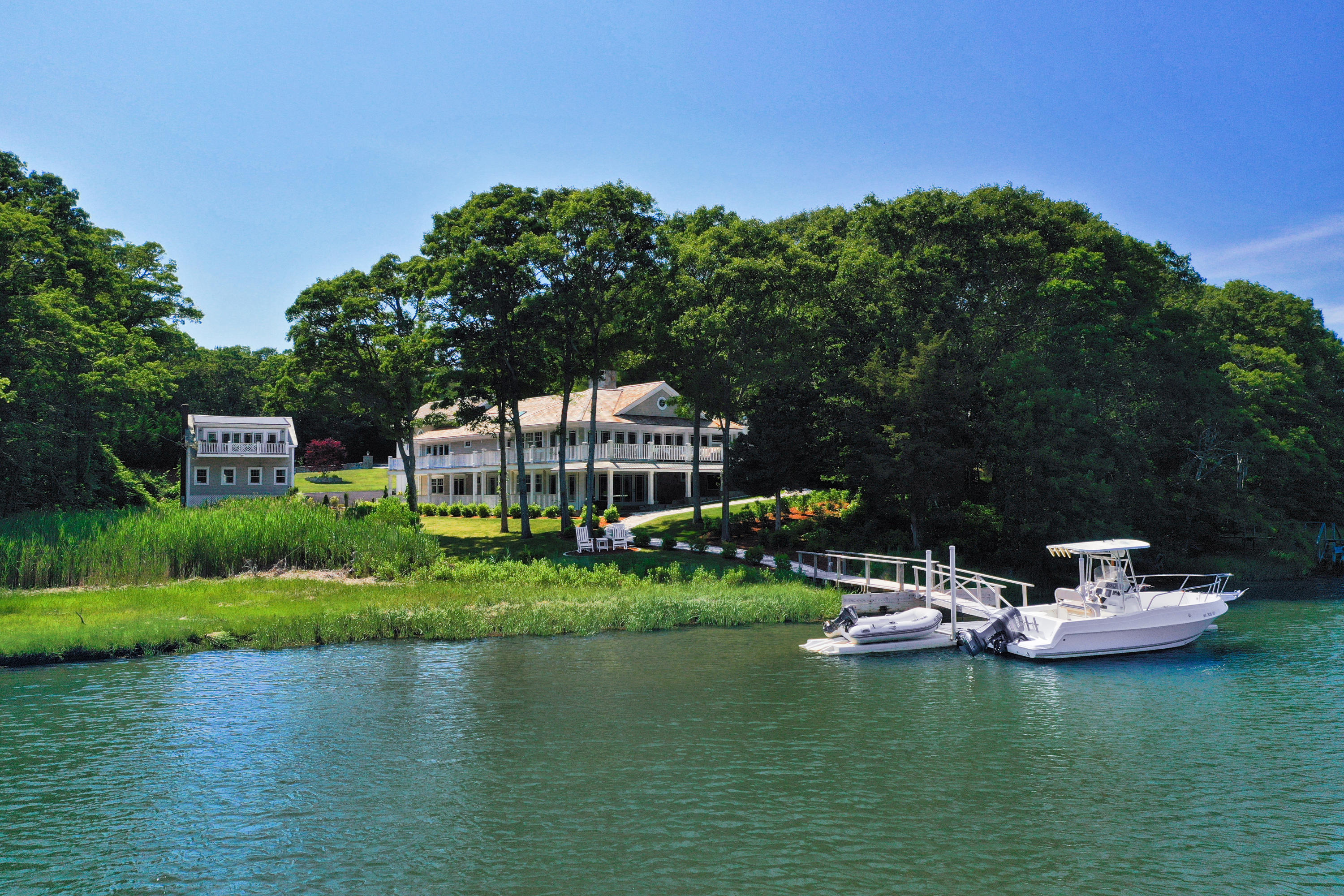 a view of a house with a yard from a lake view