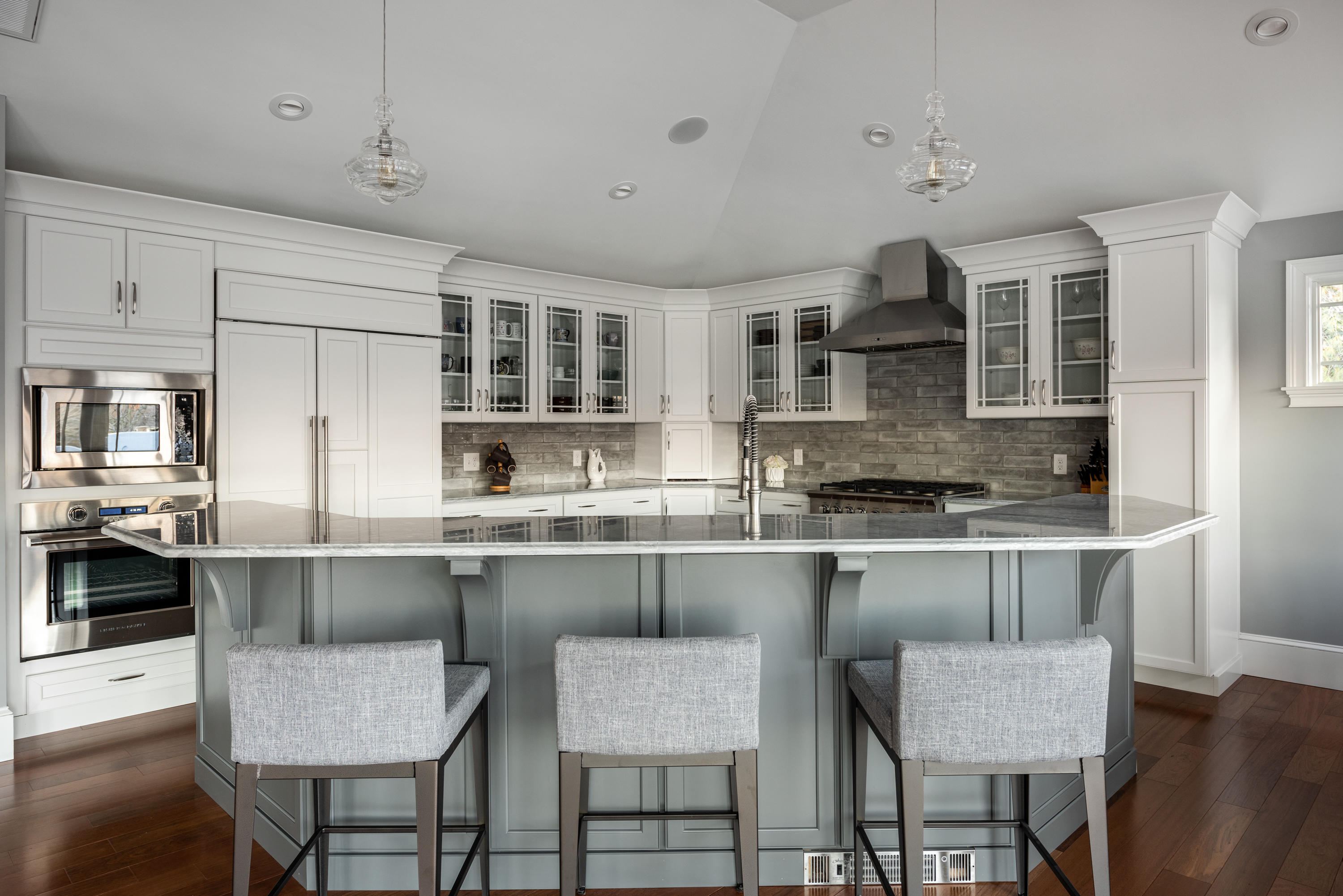 94 Starboard Lane Osterville, MA 02655 - Photo 16 of 47 a kitchen with stainless steel appliances granite countertop a stove top oven a dining table and chairs with wooden floor