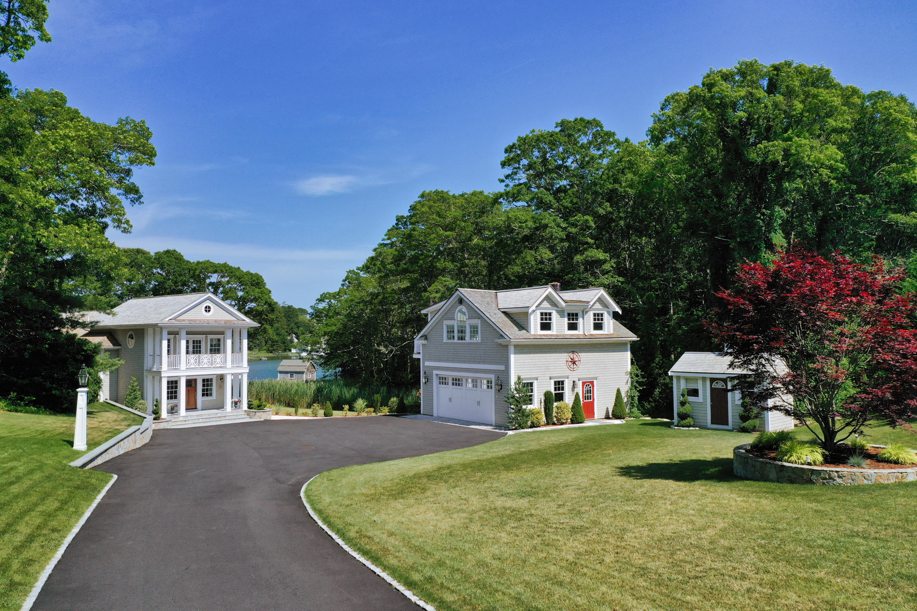 94 Starboard Lane Osterville, MA 02655 - Photo 2 of 47 a front view of a house with a yard