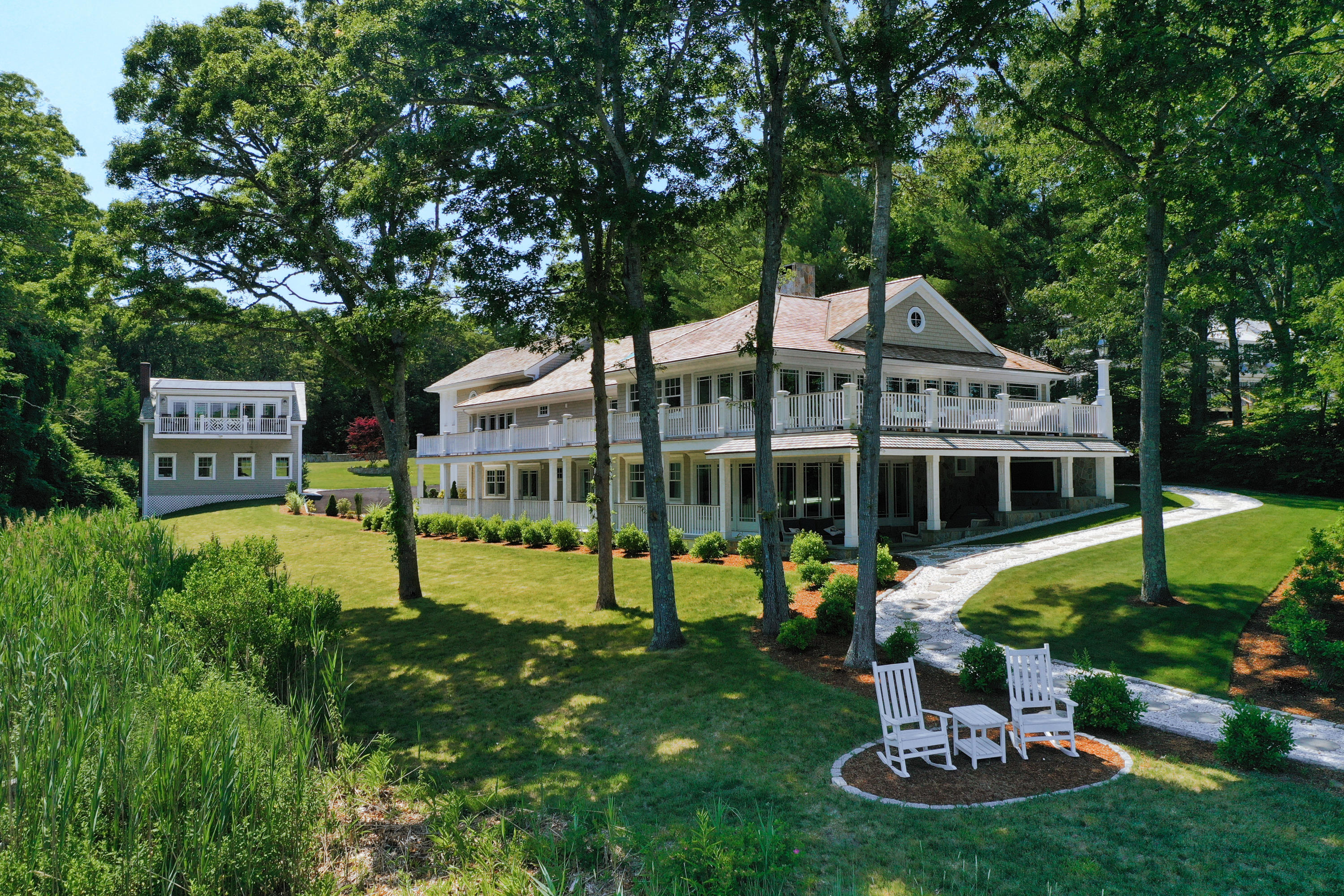 94 Starboard Lane Osterville, MA 02655 - Photo 3 of 47 a front view of a house with swimming pool and garden