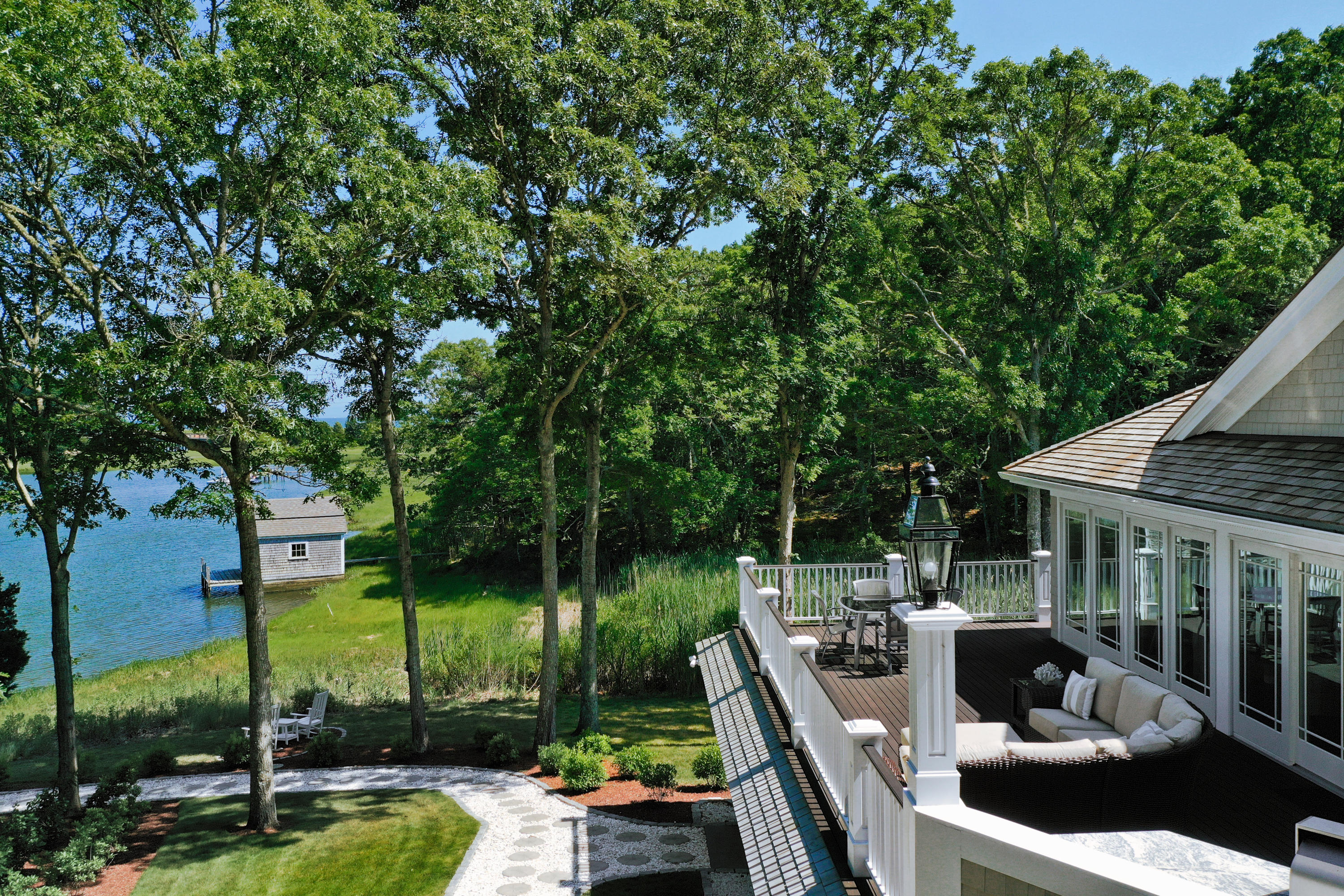 94 Starboard Lane Osterville, MA 02655 - Photo 6 of 47 a house view with a sitting space and garden view