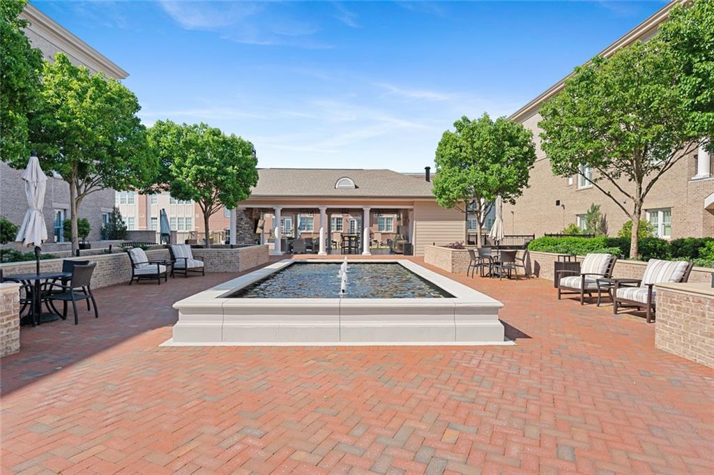 a view of house with swimming pool and sitting area