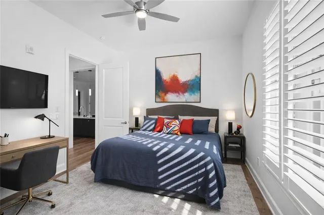 a bedroom with a bed window and a flat screen tv