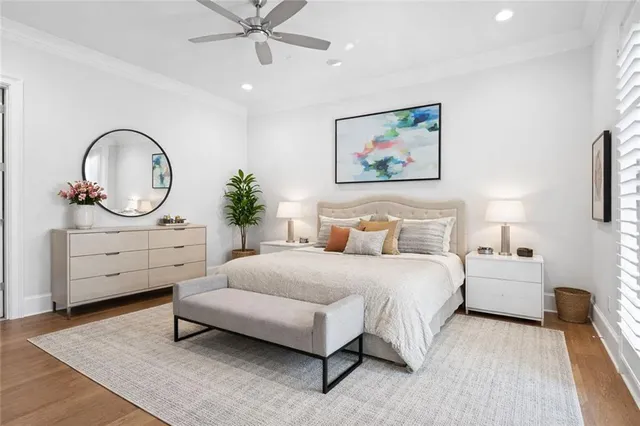 a spacious bedroom with a bed a couch and a chandelier