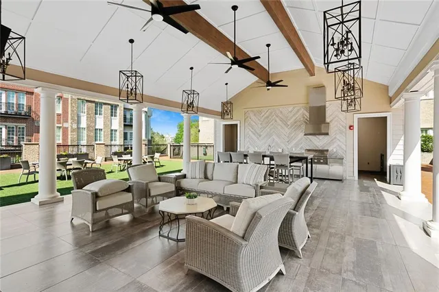 a living room with furniture and a chandelier