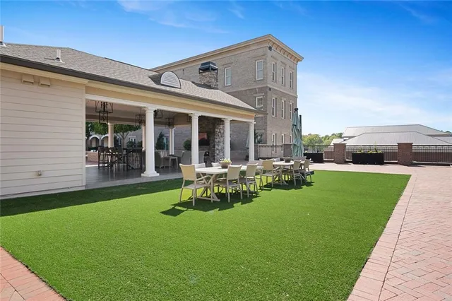 a view of a house with backyard porch and sitting area