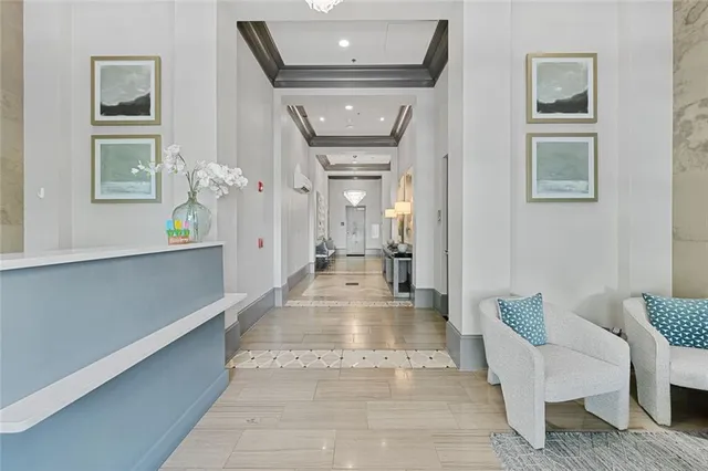a view of a hallway with couches and a potted plant