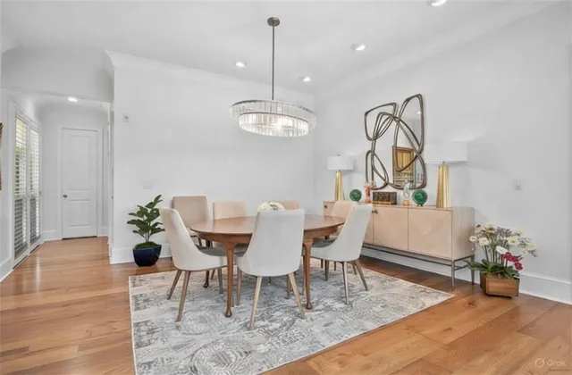 a dining room with furniture potted plants and wooden floor