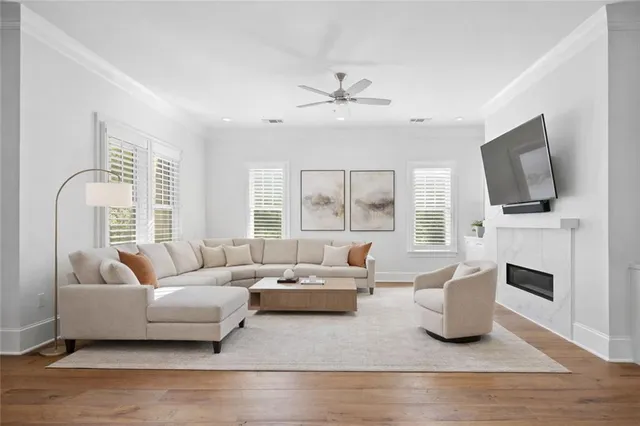 a living room with furniture a fireplace and a flat screen tv