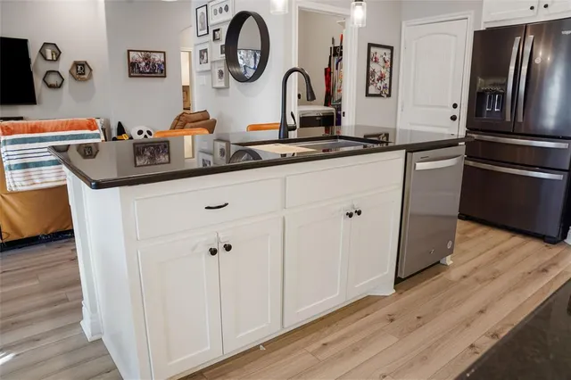 a kitchen with a sink and a refrigerator