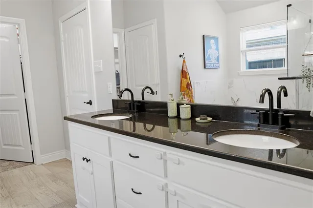 a bathroom with sink and mirror