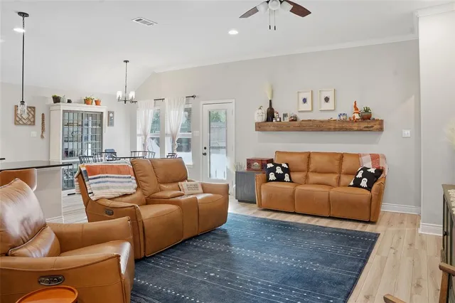 a living room with furniture a rug and a chandelier