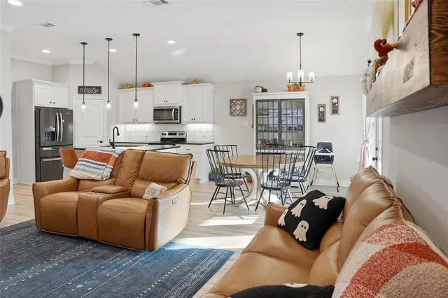 a living room with furniture and a chandelier