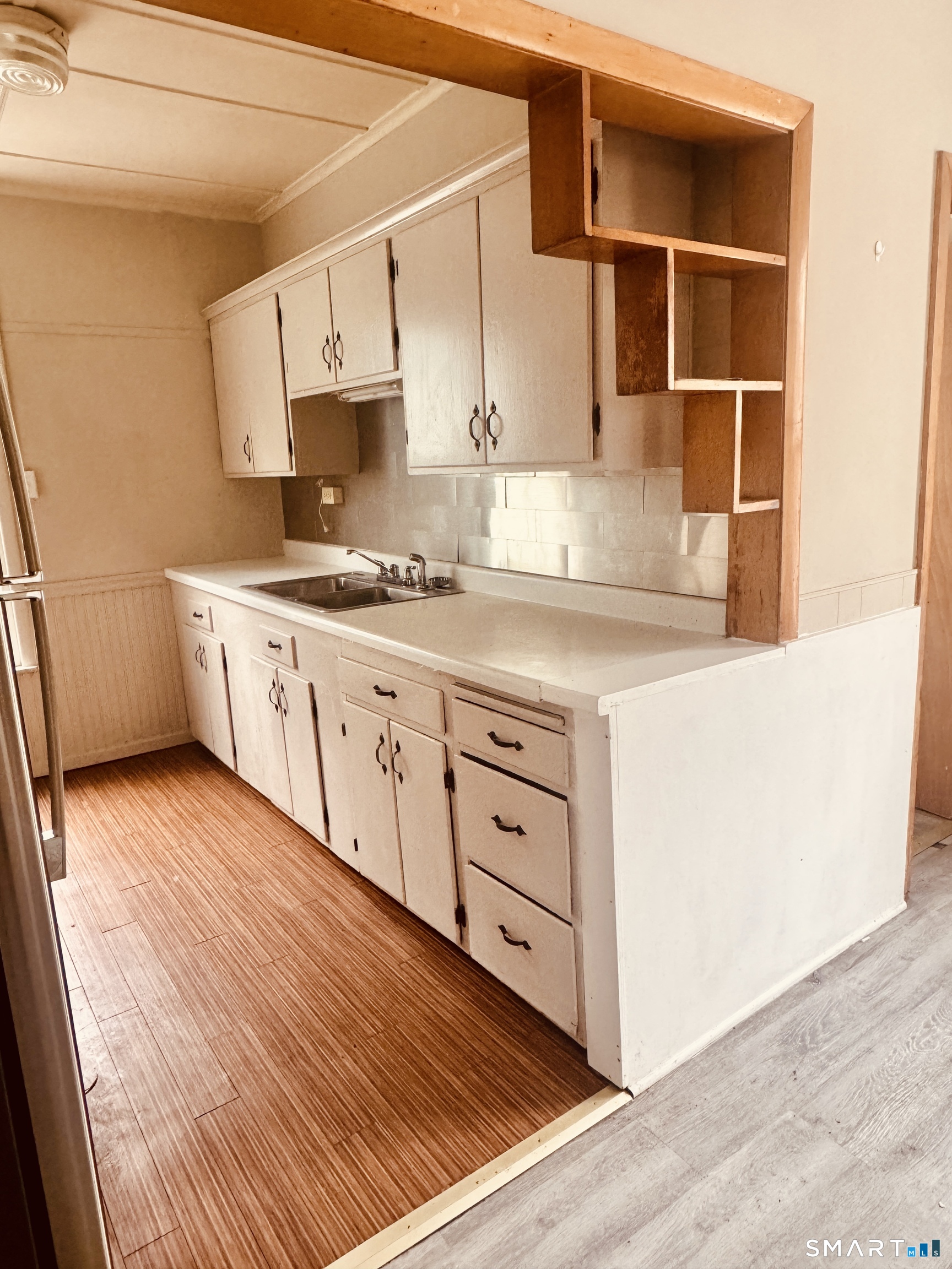 a kitchen with granite countertop white cabinets and white appliances