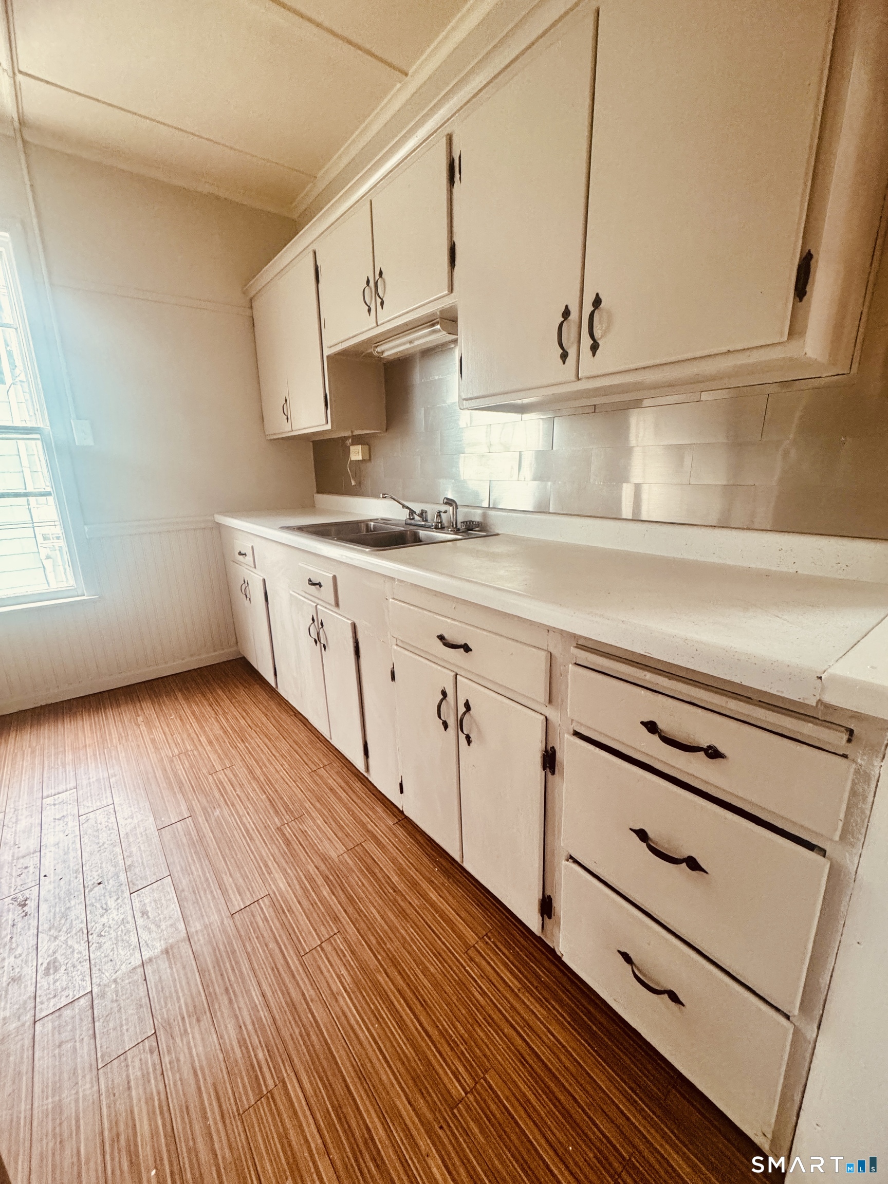 59 Green Street Waterbury, CT 06708 - Photo 2 of 6 a kitchen with granite countertop white cabinets and white appliances