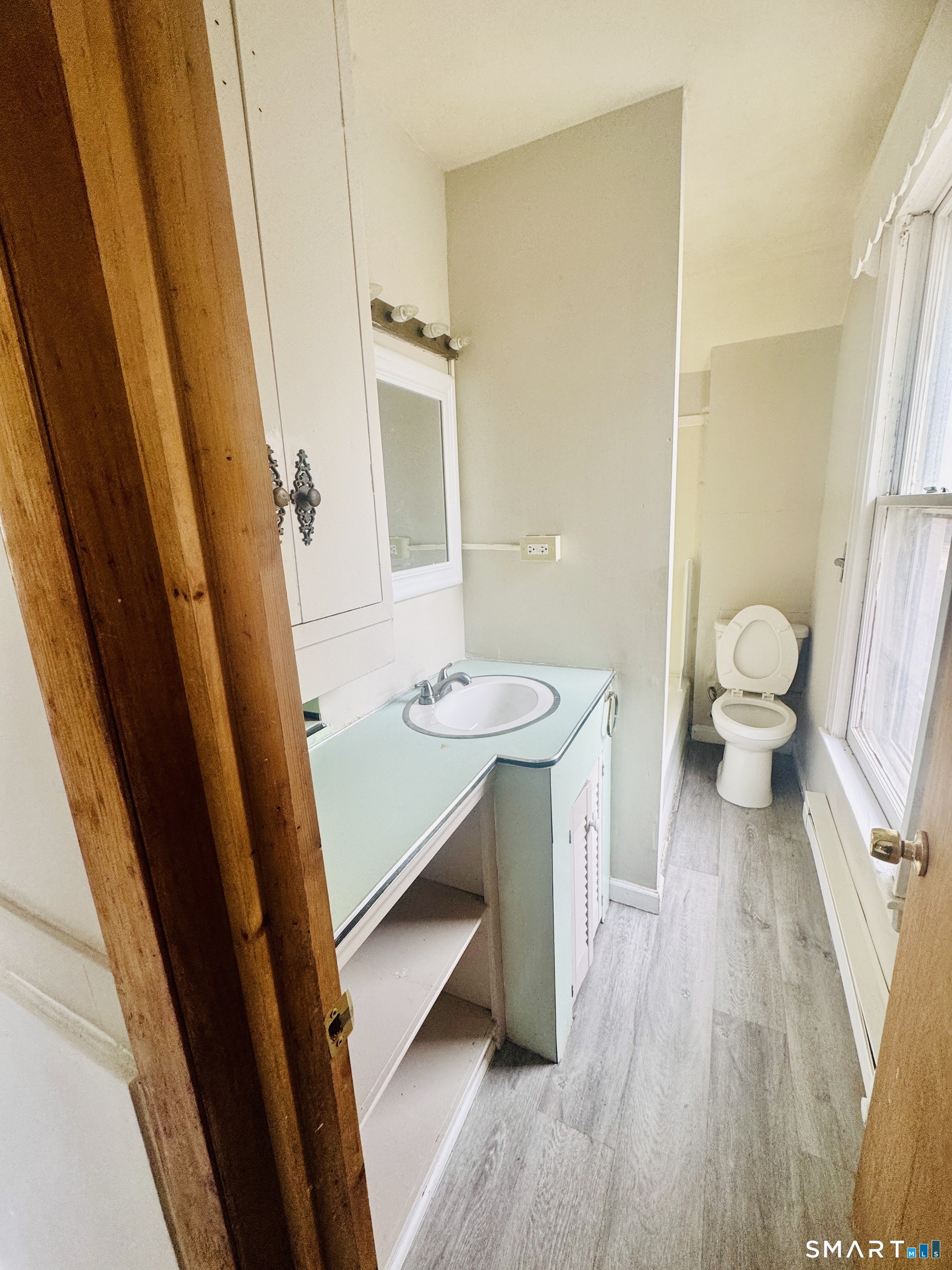 59 Green Street Waterbury, CT 06708 - Photo 5 of 6 a bathroom with a sink a toilet a mirror and shower