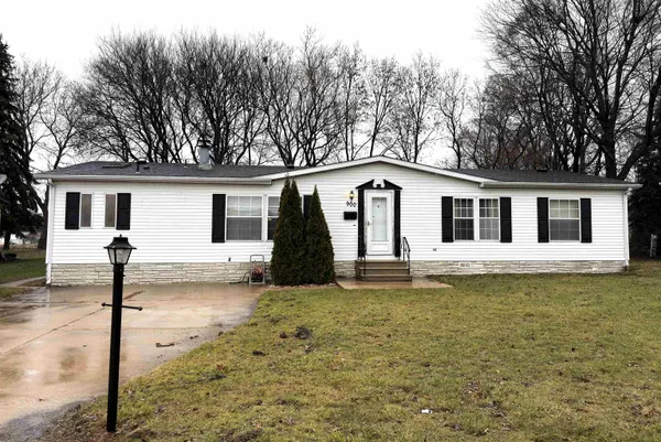 a front view of a house with a garden and yard