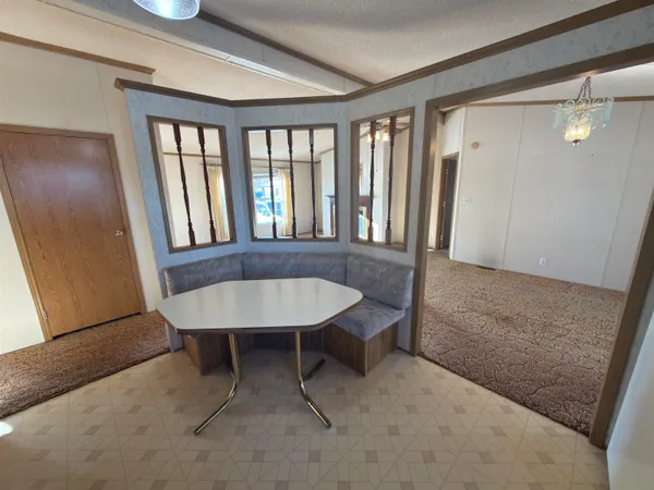 a view of a room with furniture and window