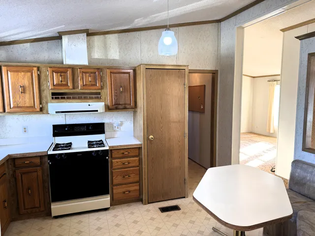 a kitchen with stainless steel appliances a refrigerator and cabinets
