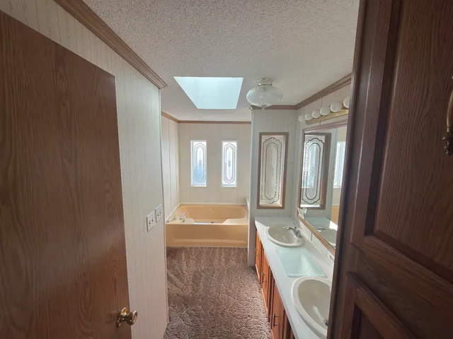 a bathroom with a tub shower and sink