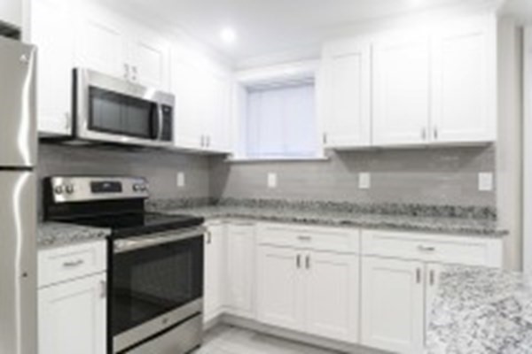 a kitchen with stainless steel appliances granite countertop a stove microwave and sink