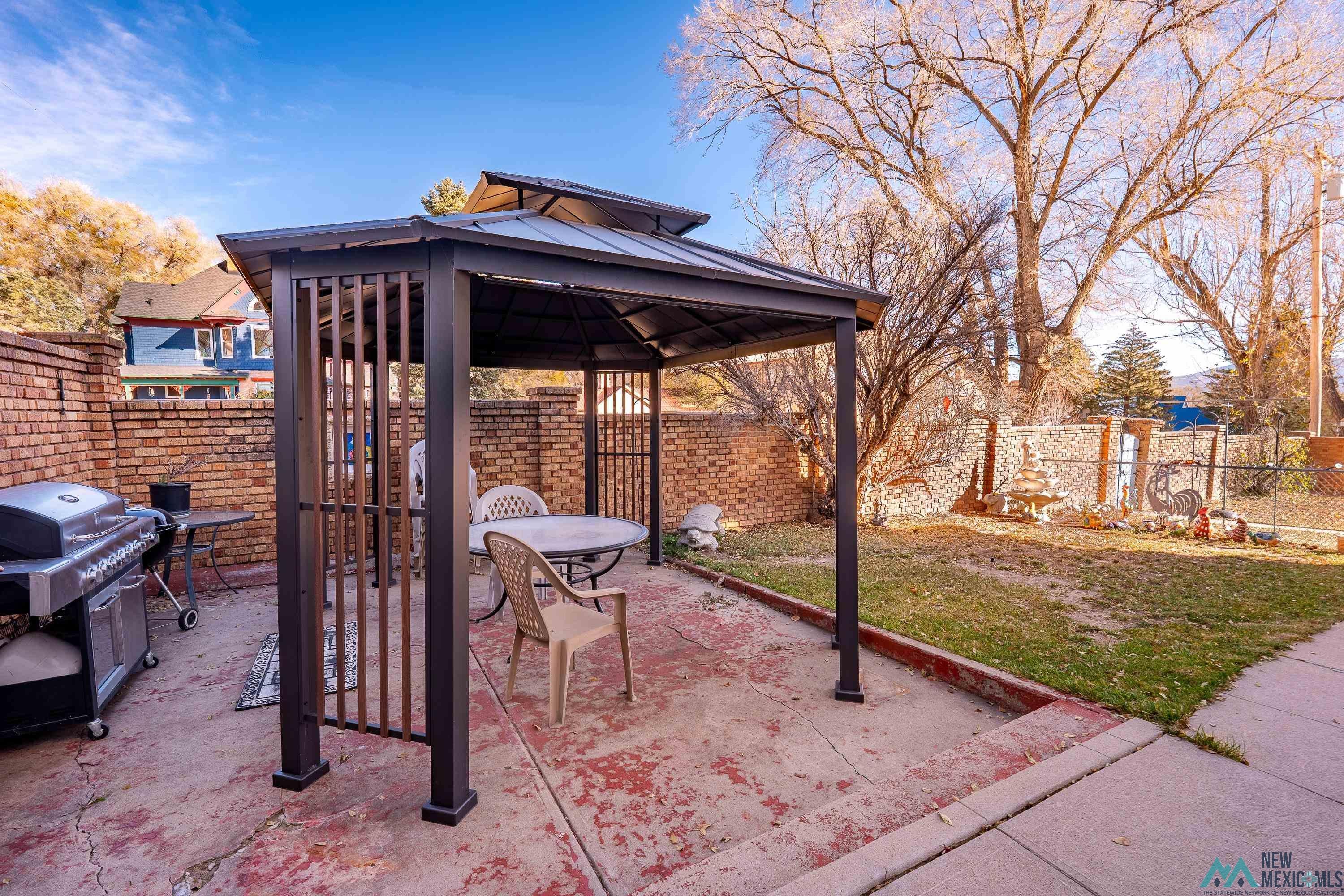 301 South 4th Street Raton, NM 87740 - Photo 45 of 78 Fenced backyard featuring a gazebo, a patio, and grilling area