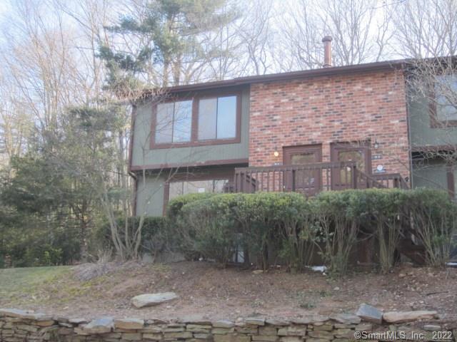 a brick building with a bench in front of it