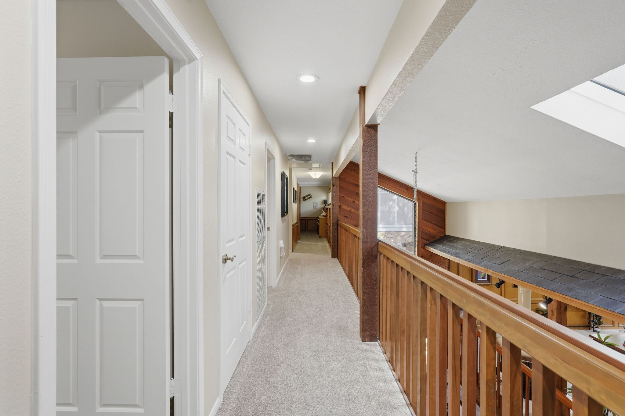 15007 Benfer Road Houston, TX 77069 - Photo 28 of 42 Balcony overlooking downstairs and beautiful lighting from your skylight this hallway leads to your media/gameroom
