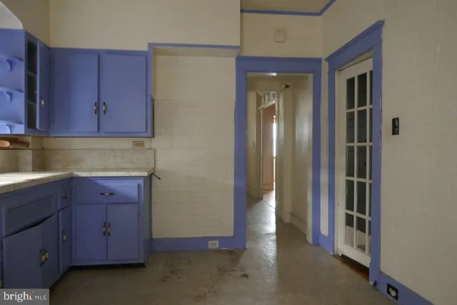 a view of hallway with cabinets and wooden floor