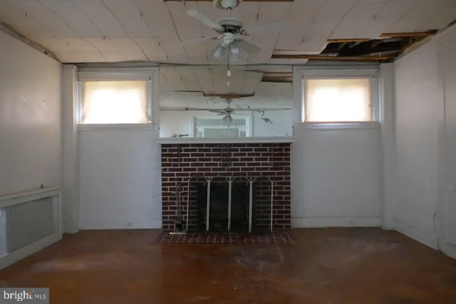 a view of empty room with a fireplace