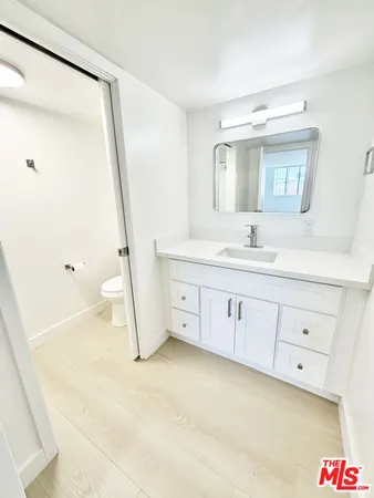 a bathroom with a sink a mirror and a shower