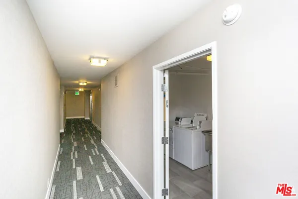 a view of hallway with bathroom