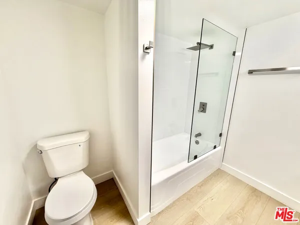 a bathroom with a toilet and a shower
