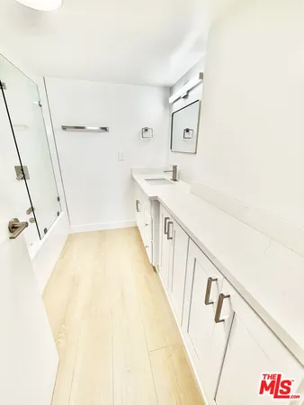 a bathroom with a tub sink and a mirror