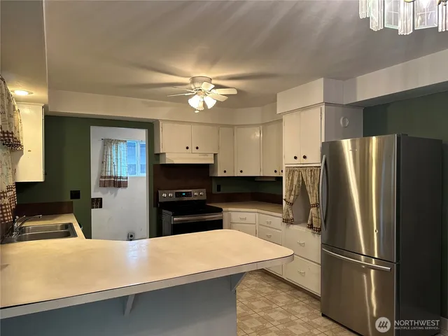 a kitchen with stainless steel appliances a refrigerator sink and stove