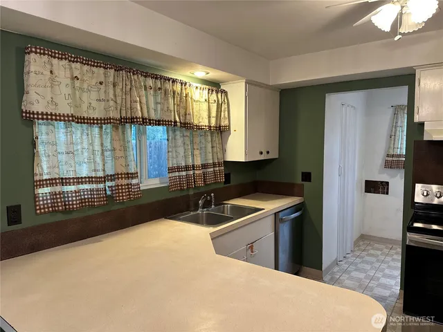 a kitchen with a sink and large window