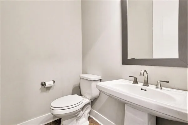 a bathroom with a sink mirror and toilet