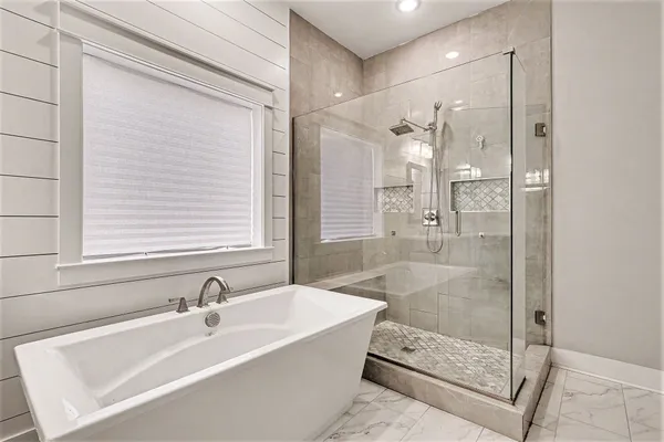 a bathroom with a bathtub and a shower
