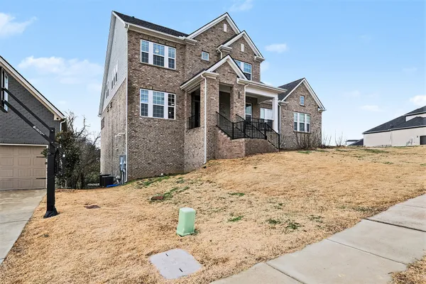 a front view of a house with a yard
