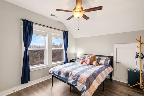a bedroom with a large bed and a tv