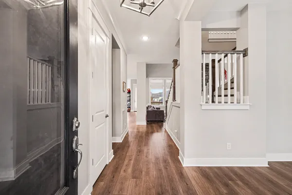 a view of a hallway with wooden floor and staircase