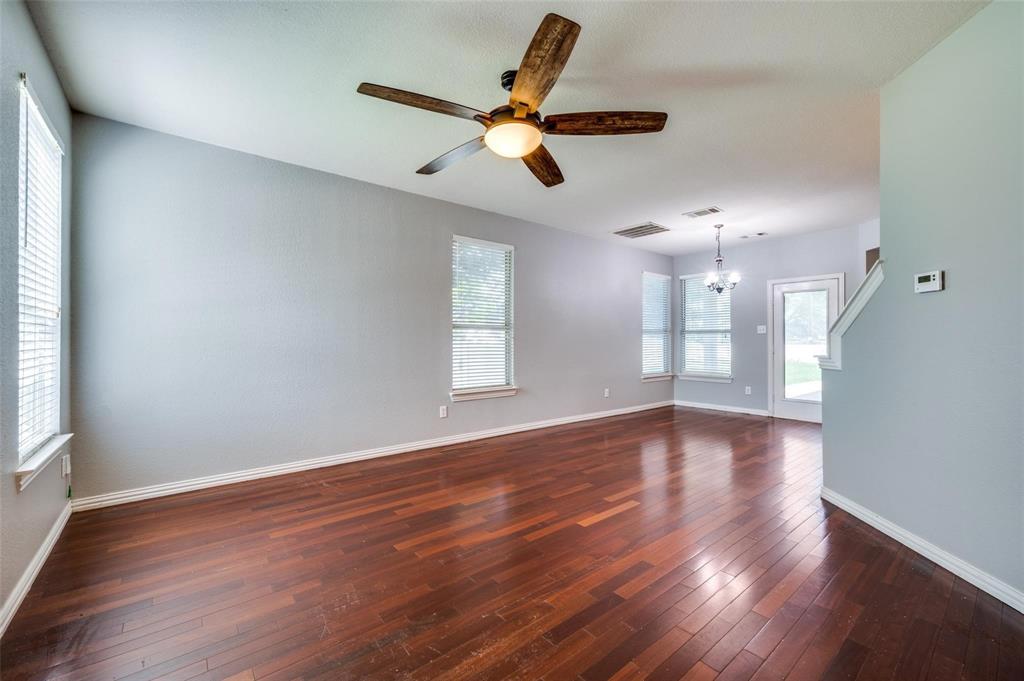 9801 Cedarcrest Drive Providence Village, TX 76227 - Photo 21 of 23 a view of an empty room with wooden floor and a window