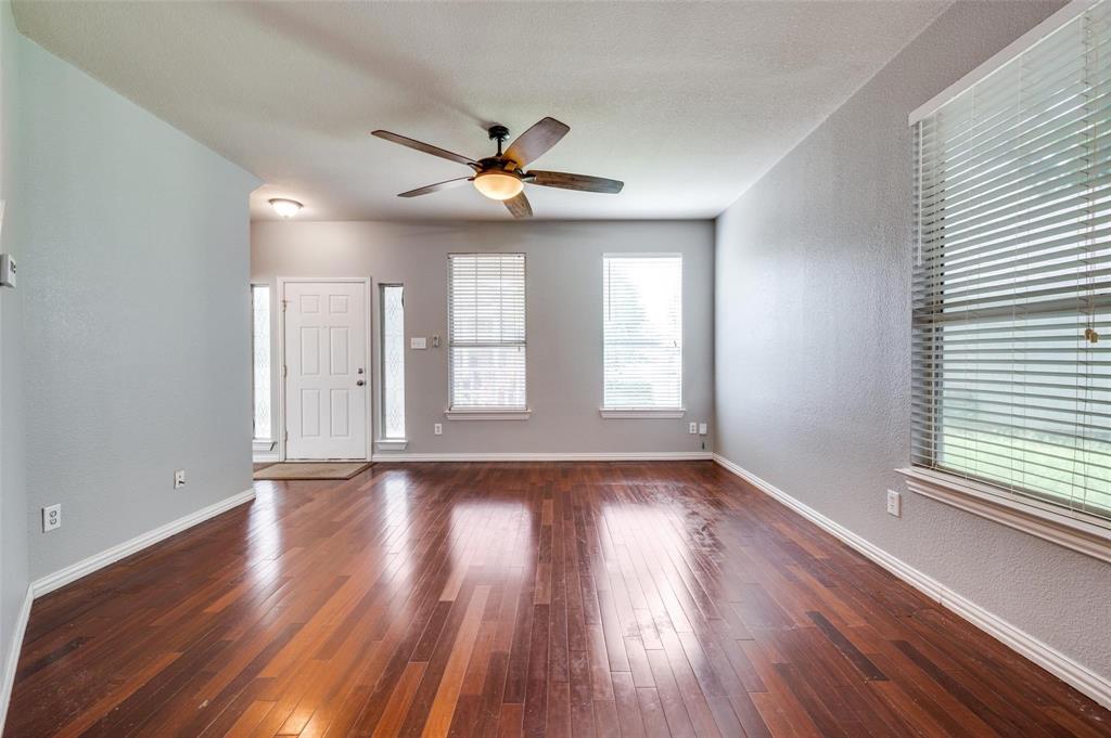 9801 Cedarcrest Drive Providence Village, TX 76227 - Photo 22 of 23 a view of an empty room with wooden floor and window