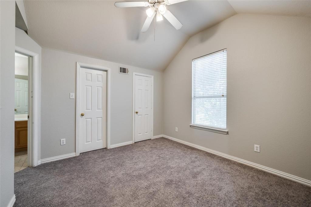 9801 Cedarcrest Drive Providence Village, TX 76227 - Photo 7 of 23 an empty room with chandelier fan and windows