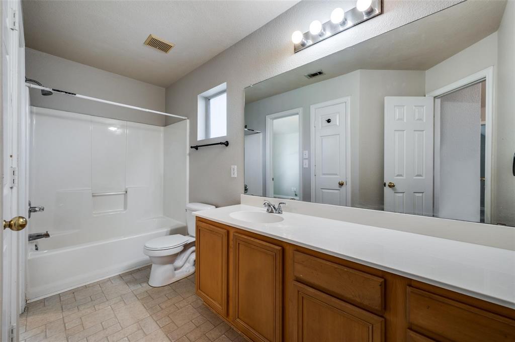 9801 Cedarcrest Drive Providence Village, TX 76227 - Photo 8 of 23 a spacious bathroom with a bathtub shower sink mirror and toilet