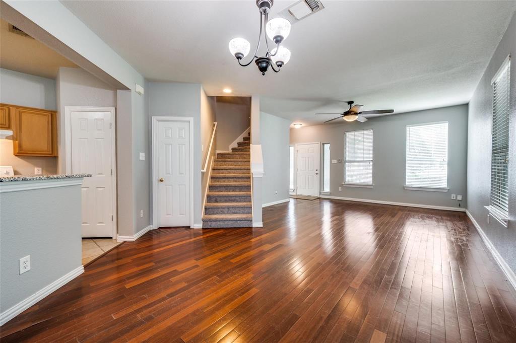 9801 Cedarcrest Drive Providence Village, TX 76227 - Photo 10 of 23 a view of a livingroom with wooden floor and a ceiling fan