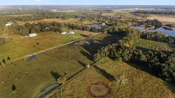 a view of a lake with houses in back