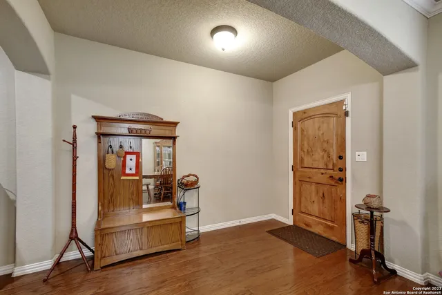 a view of a room with wooden floor pool table and windows