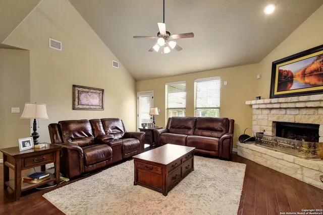 a living room with furniture and a fireplace