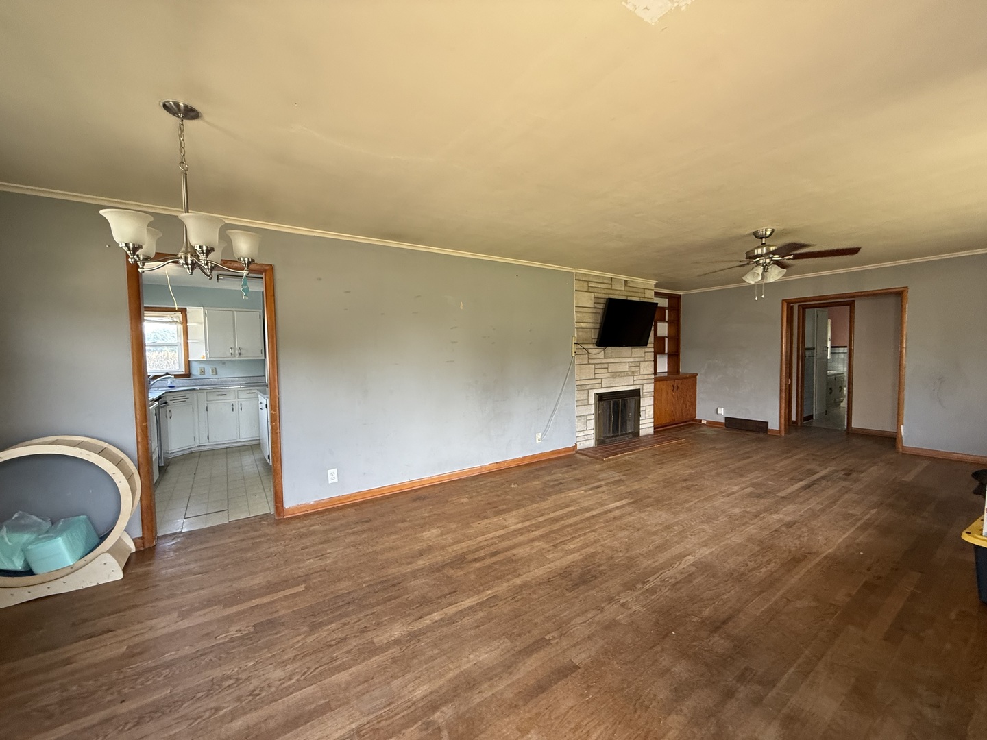 403 South Kennedy Drive Georgetown, IL 61846 - Photo 2 of 9 a view of empty room with wooden floor and fireplace